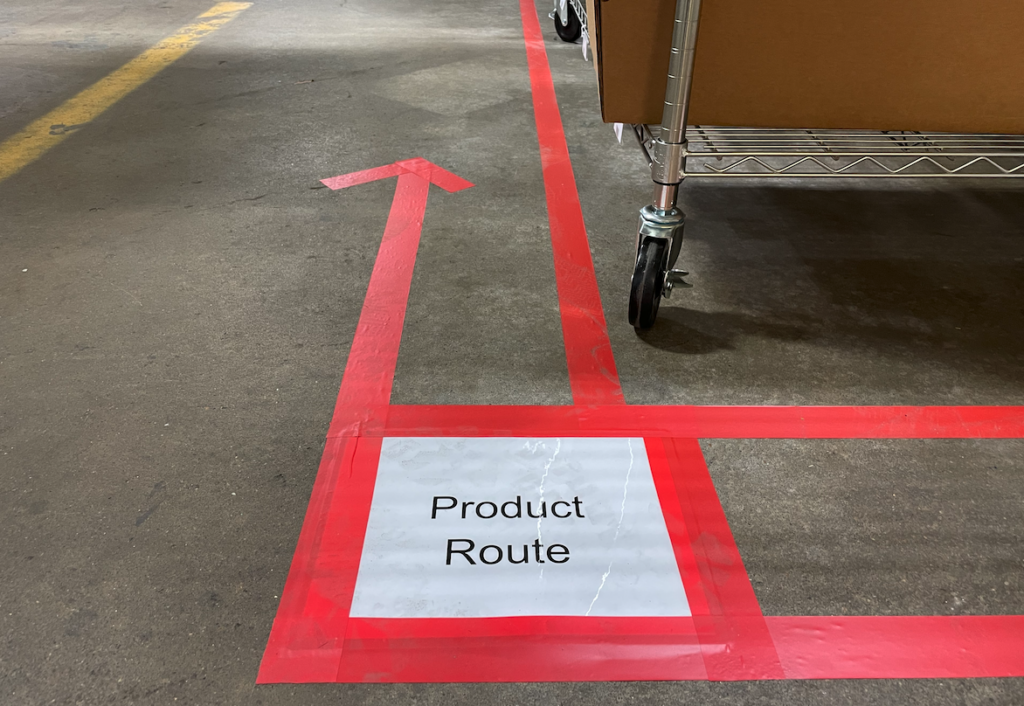 Red tape lining an e-commerce warehouse floor plan