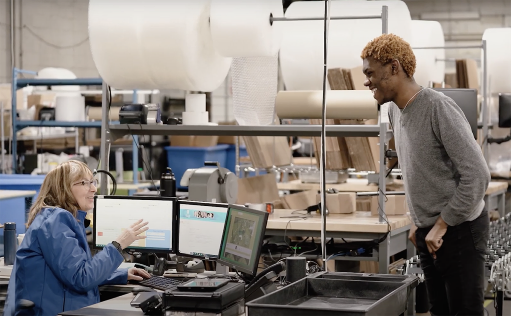 Two smiling e-commerce warehouse workers at Goodwill Delaware and Delaware County.