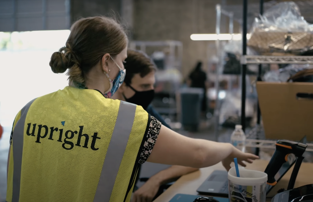 Upright Labs team member offering tech support to an integration partner in their e-commerce warehouse