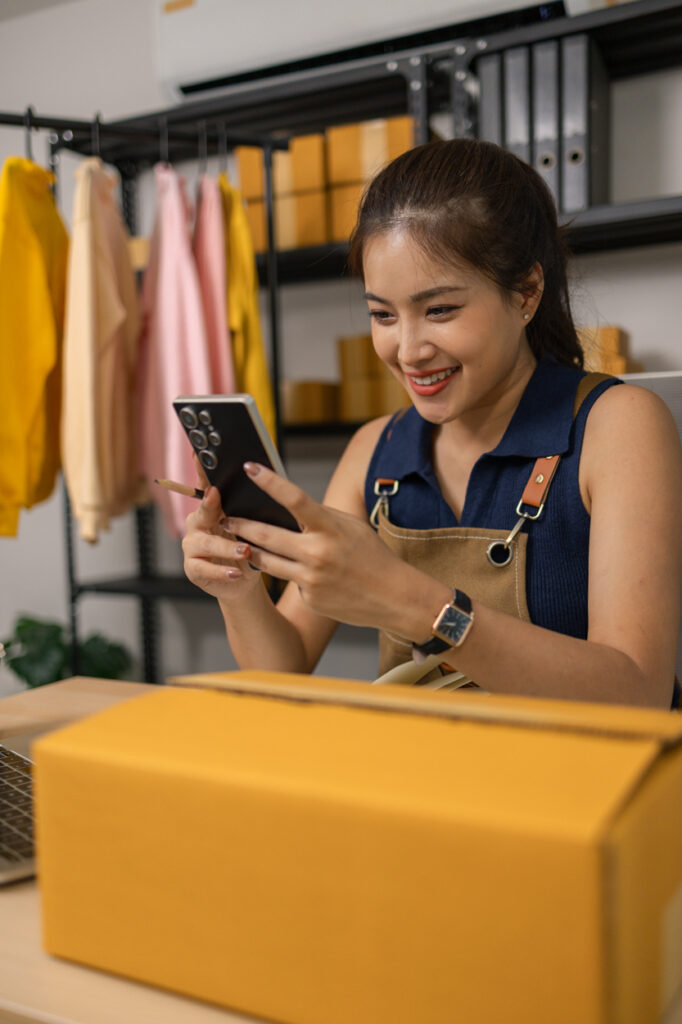 female thrift store employee checking online orders